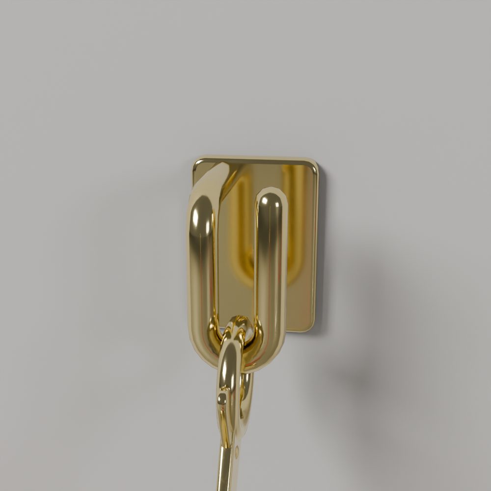 A rope's brass Wall Hook close up: a flat plate with a hook, a link and a clip hanging from it